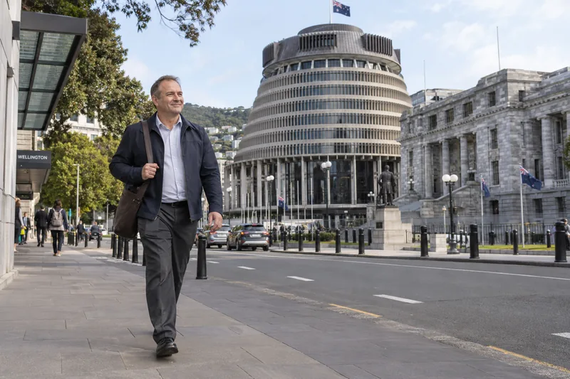 Illustrative image of an office worker walking through Wellington, with the Beehive in the background.