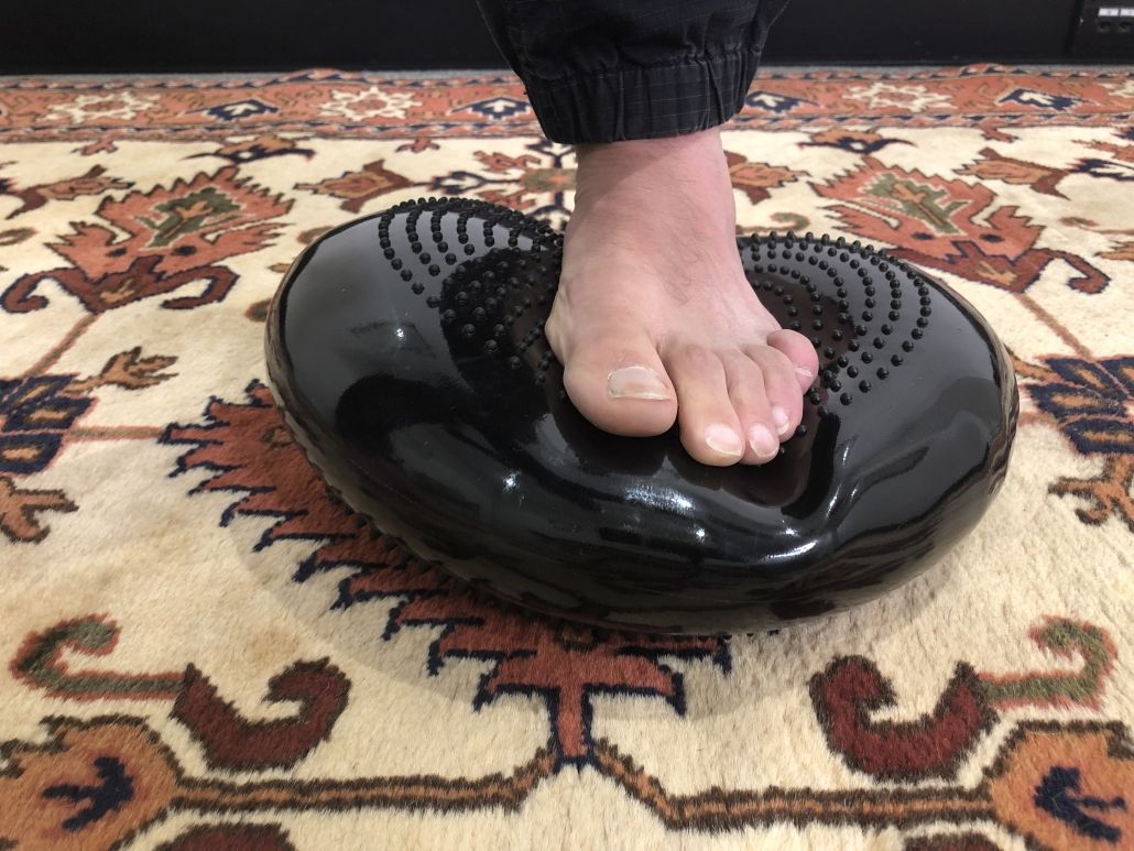 Image of someone standing on a posture pad.