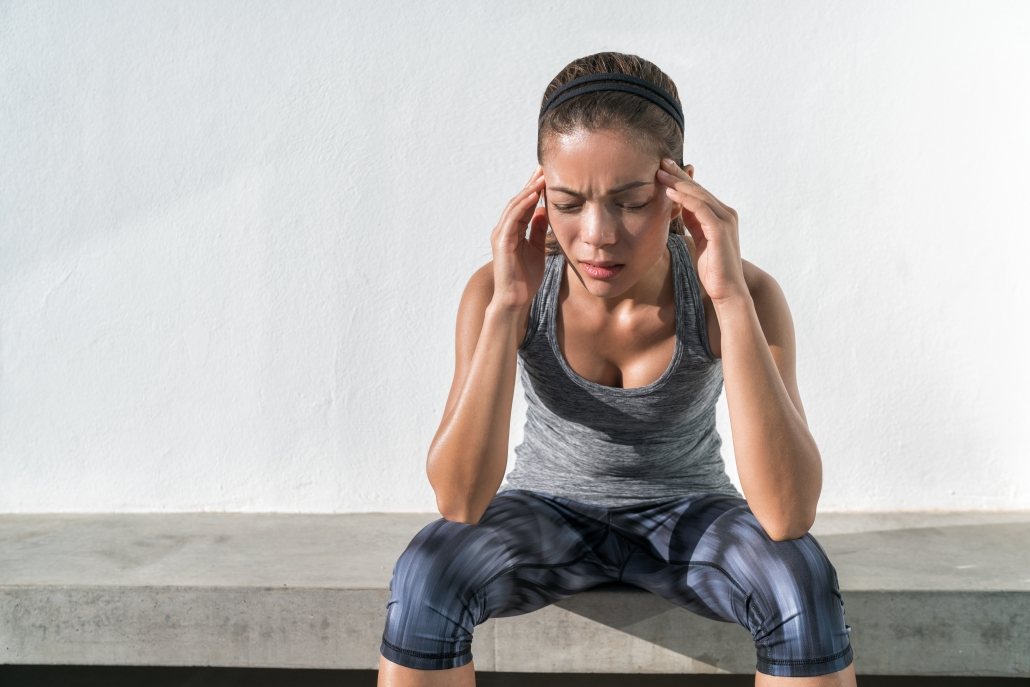 Image of lady who has clearly been suffering with headaches and/or migraine headaches for some time. She has suffered because she normalised her headaches and just put up with them.