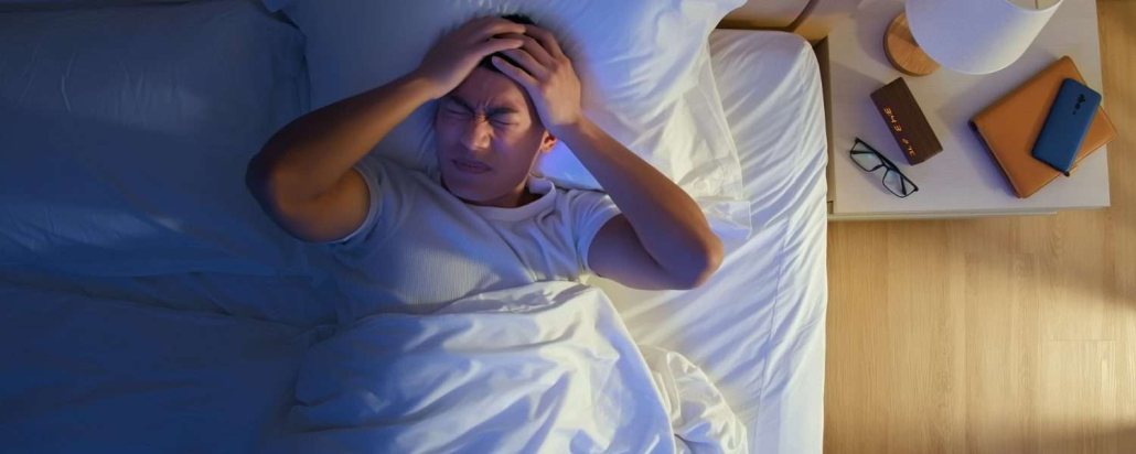 A wakeful person lying in bed at night
